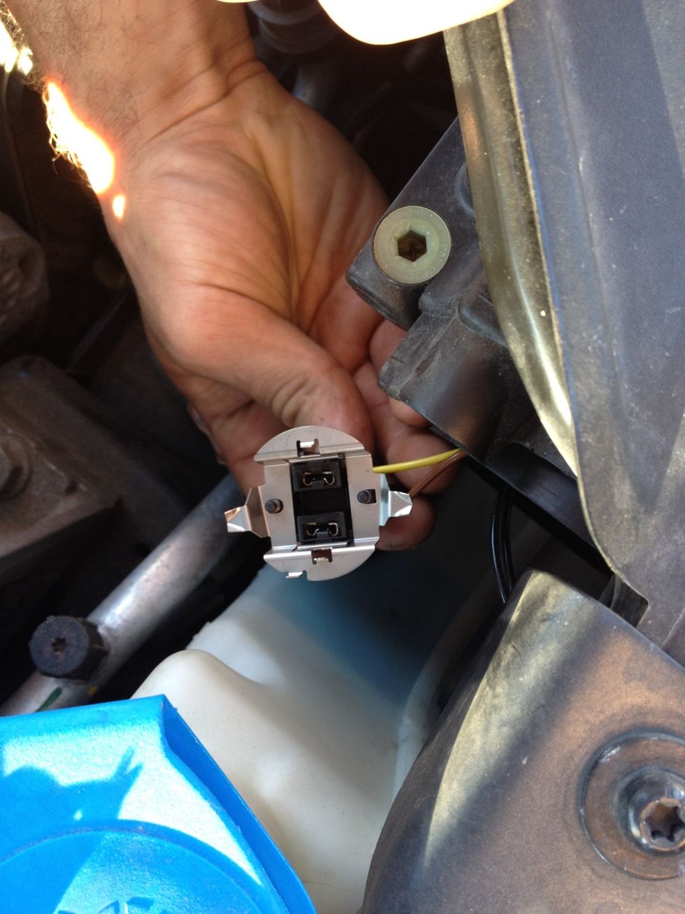 Here is the socket that was in the housing with the bad bulb already removed. Don't touch the hot bulb - ouch! The socket needed a slight twist to remove from the housing bracket to gain access.