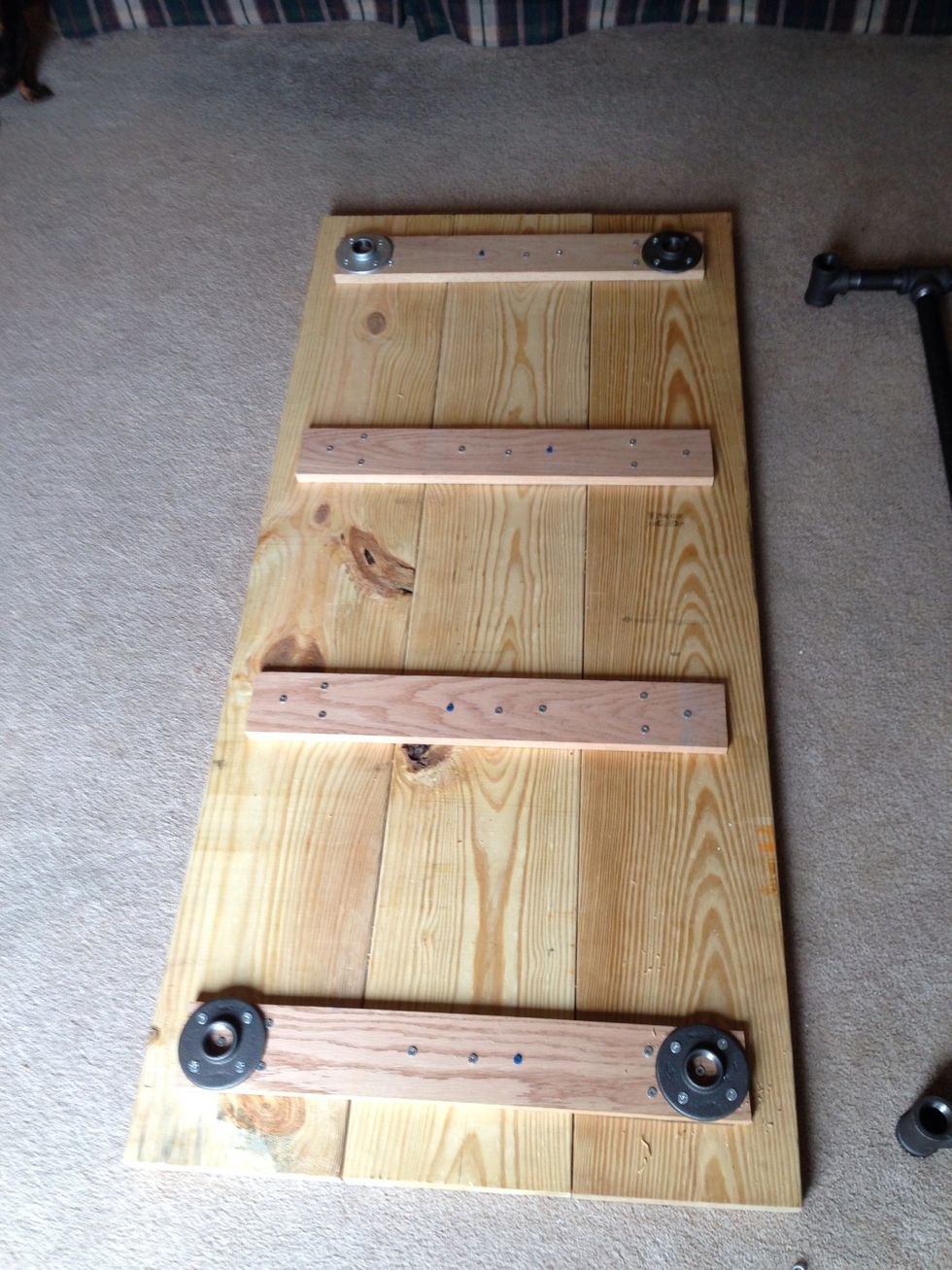 Here is what it will look like with all 4 flanges attached. We will remove these later to attach the base pipes. We are only attaching them now so we can stand it up for staining.