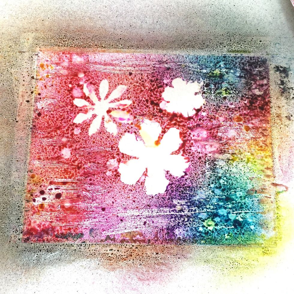 here is what the plate looked like once the flowers were removed. follow the same steps as before: covering the plate with dictionary page, then cover sheet, then rolling.