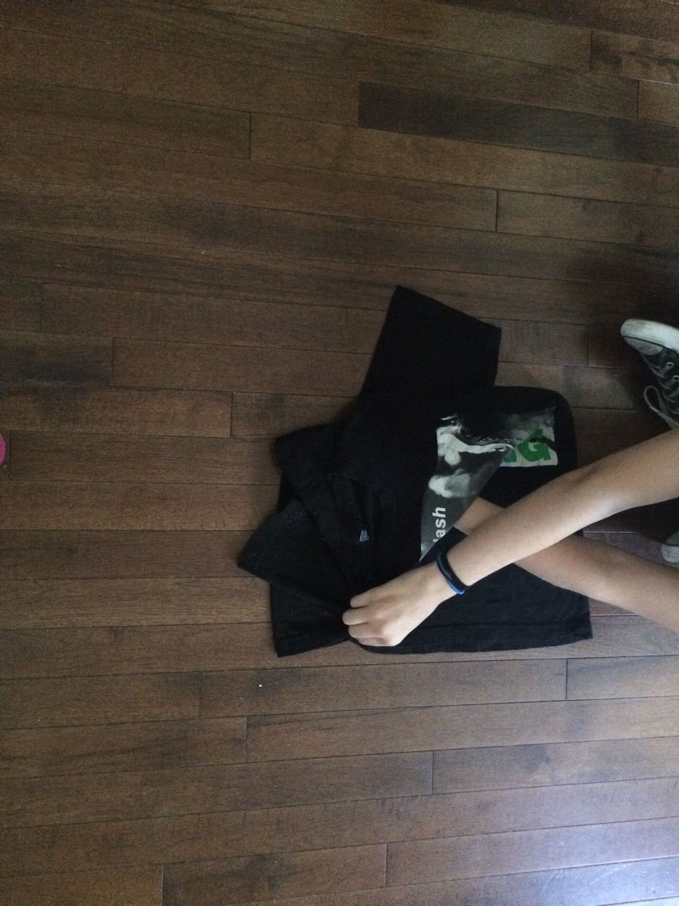 Here is where it gets hard.....fold your top hand over the bottom one and pinch the bottom of the shirt