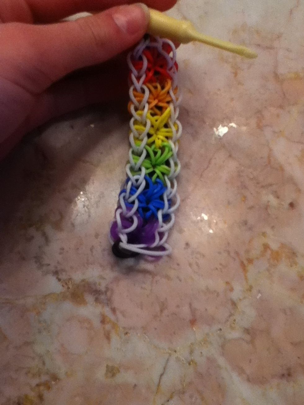 Here it is! We're almost done! Grab the red side of the braclet.