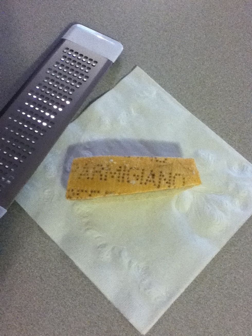 Here's a bit of trivia: by law of the EU, all real Parmesan cheese must have the word 'Parmigiano' stamped all over the rind. Find an Italian grocery & treat yourself. You should grate about 3-4 tbsp.