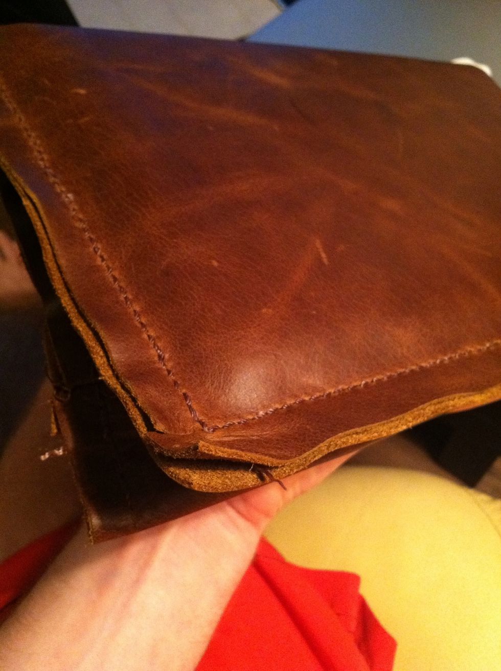 Here's a shot of the back with the iPad inside. I like the used rustic look, so I wasn't too worried about the mangled edge ;) see how tight the leather is around the iPad! That's what you want.
