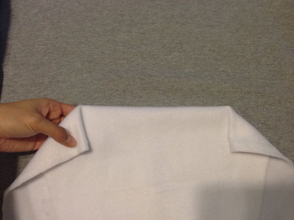 Here's an example of the top part of the pocket with the white fleece glued down. I stuck my hands in so u can see where to not apply glue. Now glue going up to the top. Thin layers along the edges.