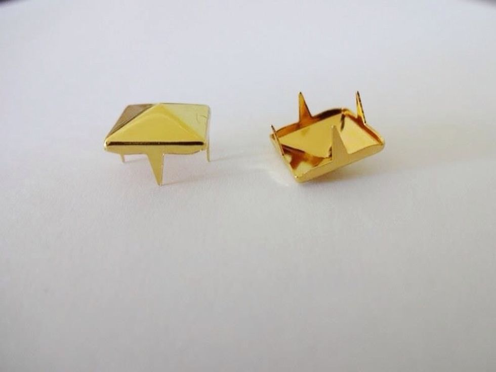 Here's another picture. You can see the prongs of the studs. Don't worry, we'll be folding them down. You won't end up with 4 extra ear piercings!