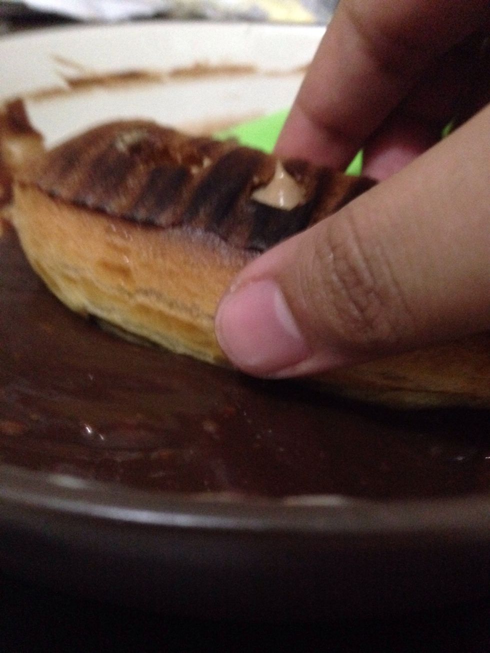 Here's I'm dipping the top of my eclair to chocolate glaze