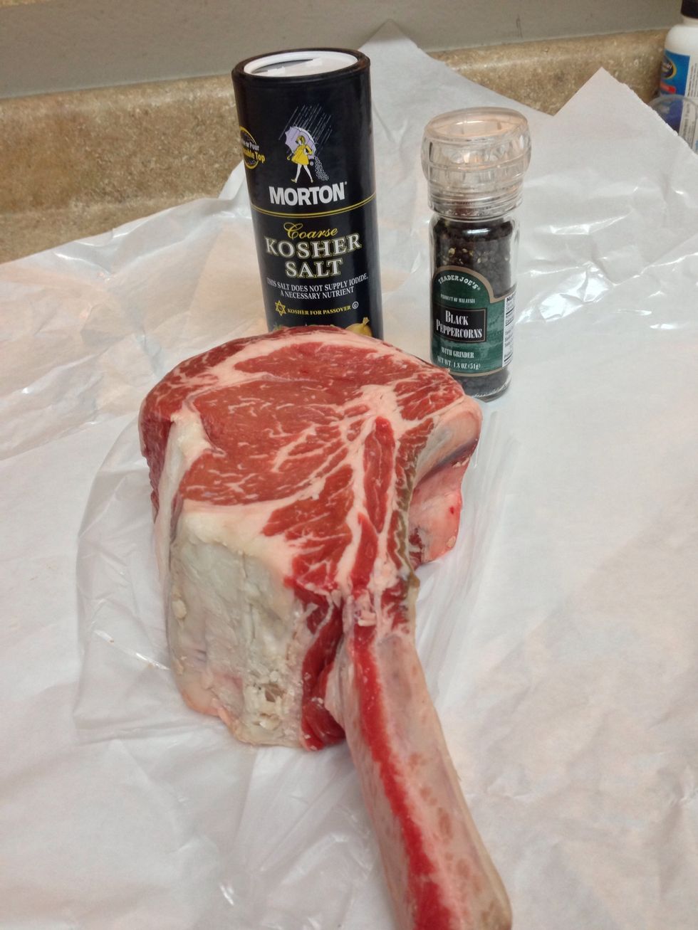 Here's my nearly 3 pound, bone in cowboy ribeye. Also my kosher salt and pepper grinder. We're going to reverse sear this so it will take anywhere from 1 1/2 to 3 hours depending upon preparation.