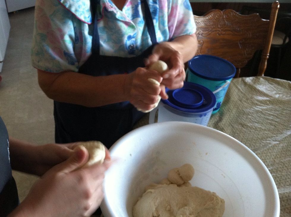 Here's our technique. Hold the dough in one hand and squeeze out a golf ball size ball. It's harder than it looks. Practice makes perfect!