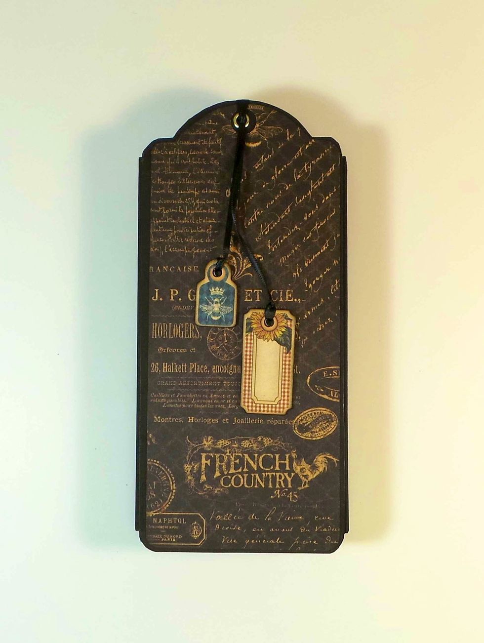 Here's the Back Cover with the charms. I used a Lark's Head knot -- Fold ribbon in half - stick resulting loop through eyelet from inside, drop ends through loop and adjust lengths as desired.