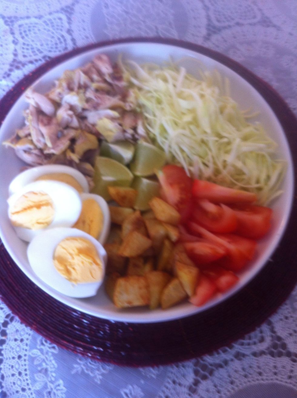 Here's the condiment for the soup. Eggs,shredded cabbage,tomatoes, chicken and lime.