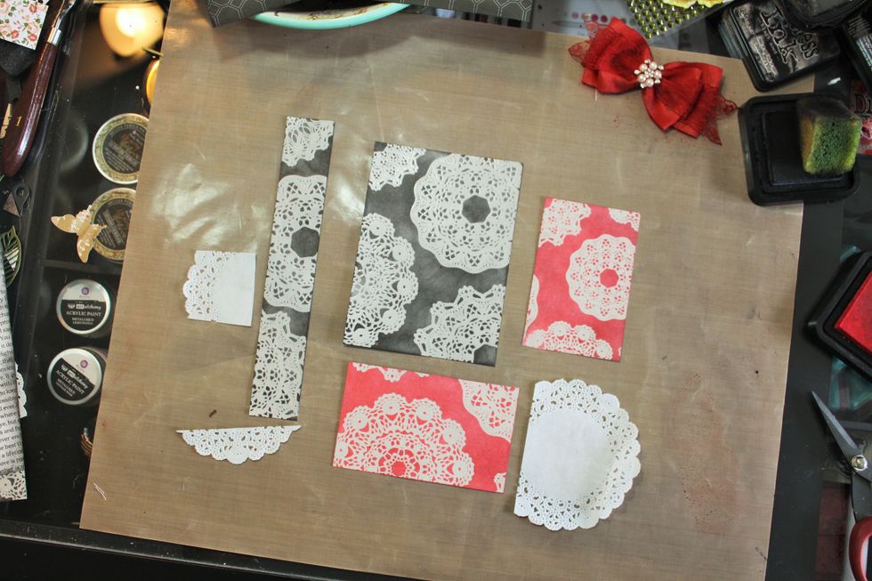 Here's the cuts for remaining Kaiser resist paper, used Distress ink in Black Soot & Worn Lipstick. I found these bits of  doily on my desk. You could cut doilies from the patterned paper or use a die