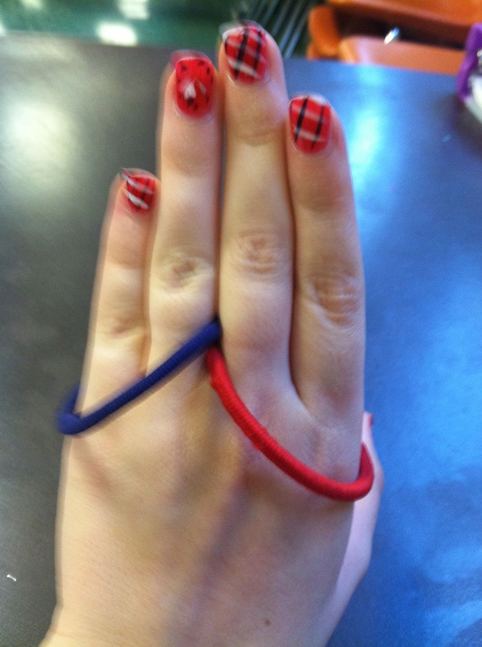 Here's the variation. Put two hair ties on like this. Different colors work better for the trick.