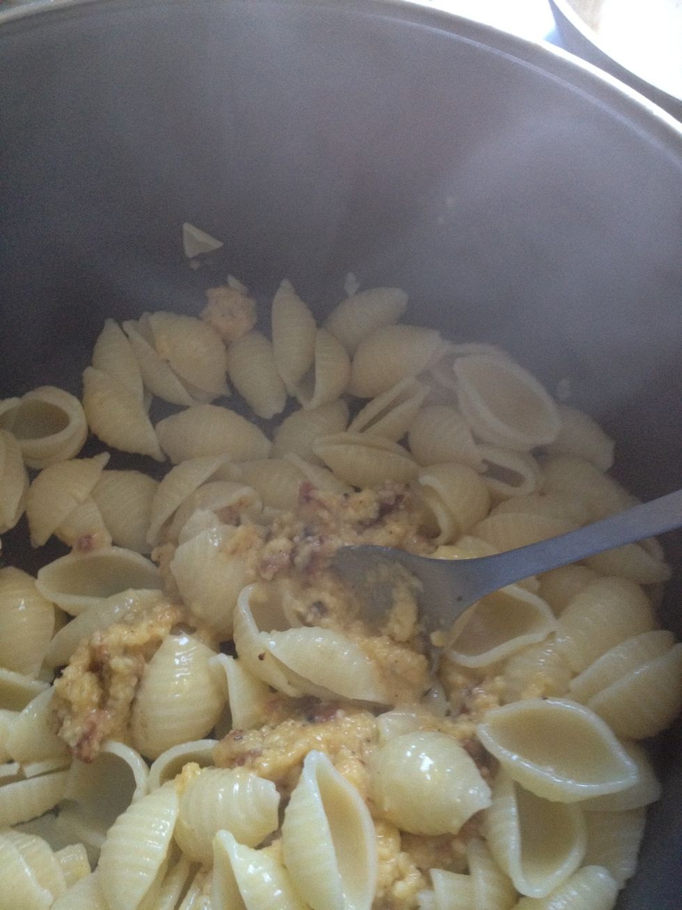 Here's where you need to move fast\u2026 Return the pasta to your pot and quickly add in the cheese-egg- bacon mixture and stir rapidly. The heat of the pasta cooks the mixture into creamy deliciousness!