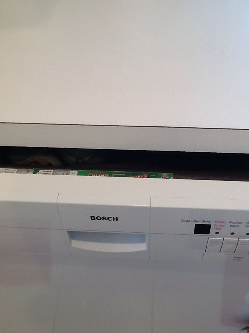 Here's why the door is open- you can sift flour to the edge of the counter without sifting directly on the floor. Later, you'll push the dough into the bowl over the open door. Genius.