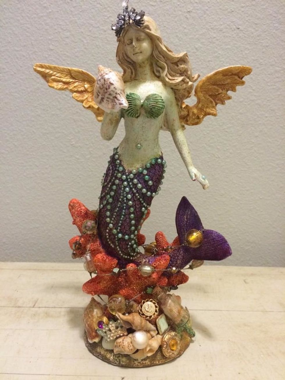 Here she is completed. I draped an old necklace around the coral and her tail. She has all of her bobbles and bits she has collected. She is the Angel of the Sea.