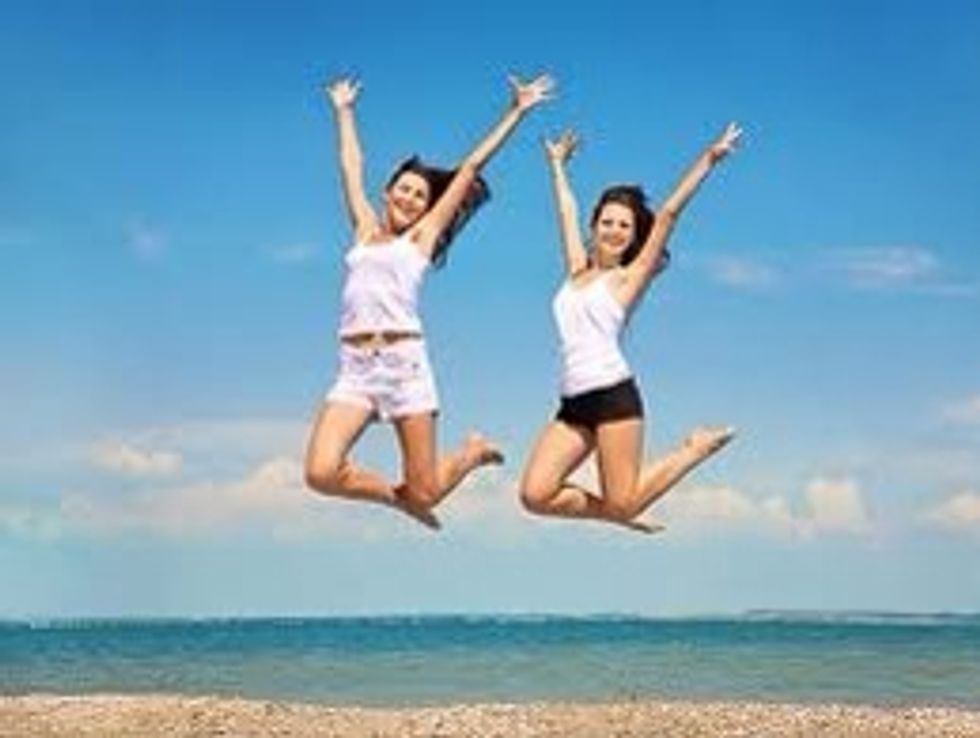 Here we have two girls jumping for joy.