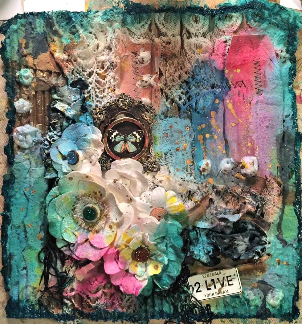 Here you can see all of the layers of color I have added. My embellishments are not glued down yet because I have stamping to do. I used butterfly stamp, white ink, and embossing powder