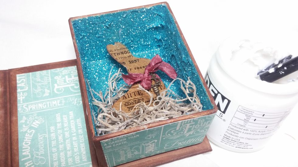 Here you can see I have added my die cut rabbit. I used a scrap of chipboard layered with tissue paper covered in Ice Resin to give my rabbit some texture.