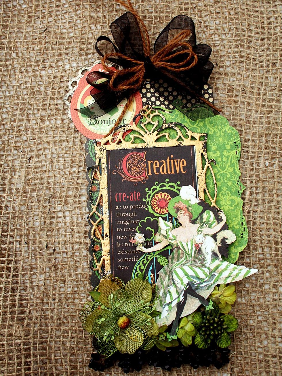 Here you can see that I added a circle frame behind the Bonjour sitcker.  Add ribbon at the top and flowers at the bottom.  That's it!