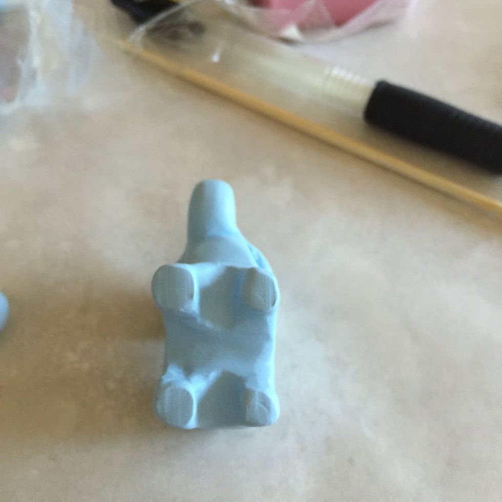 Here you can see the feet are smooth and flat. To do this, stand elephant on flat surface and push into surface OR roll out each foot with a pen.
