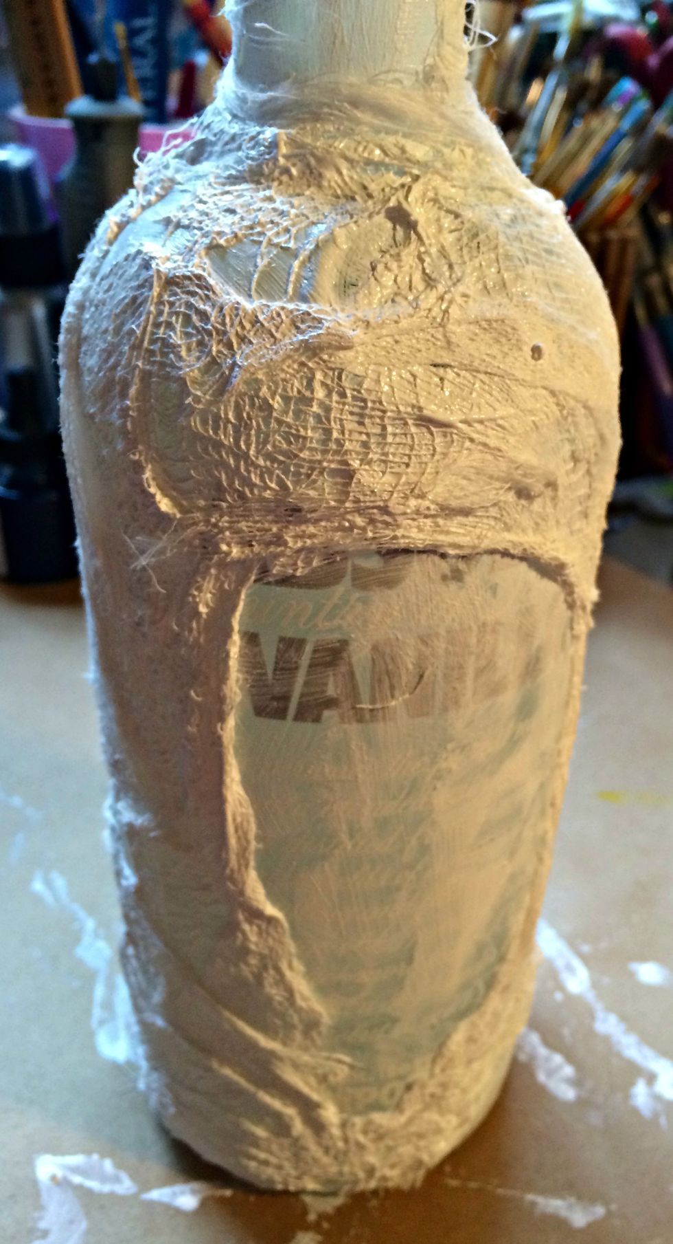 Here you can see the gauze and gesso. I have left a window area where I will be applying my image a little later on. Now grab your crochet doily. I cut mine up. I wanted it to look like netting.