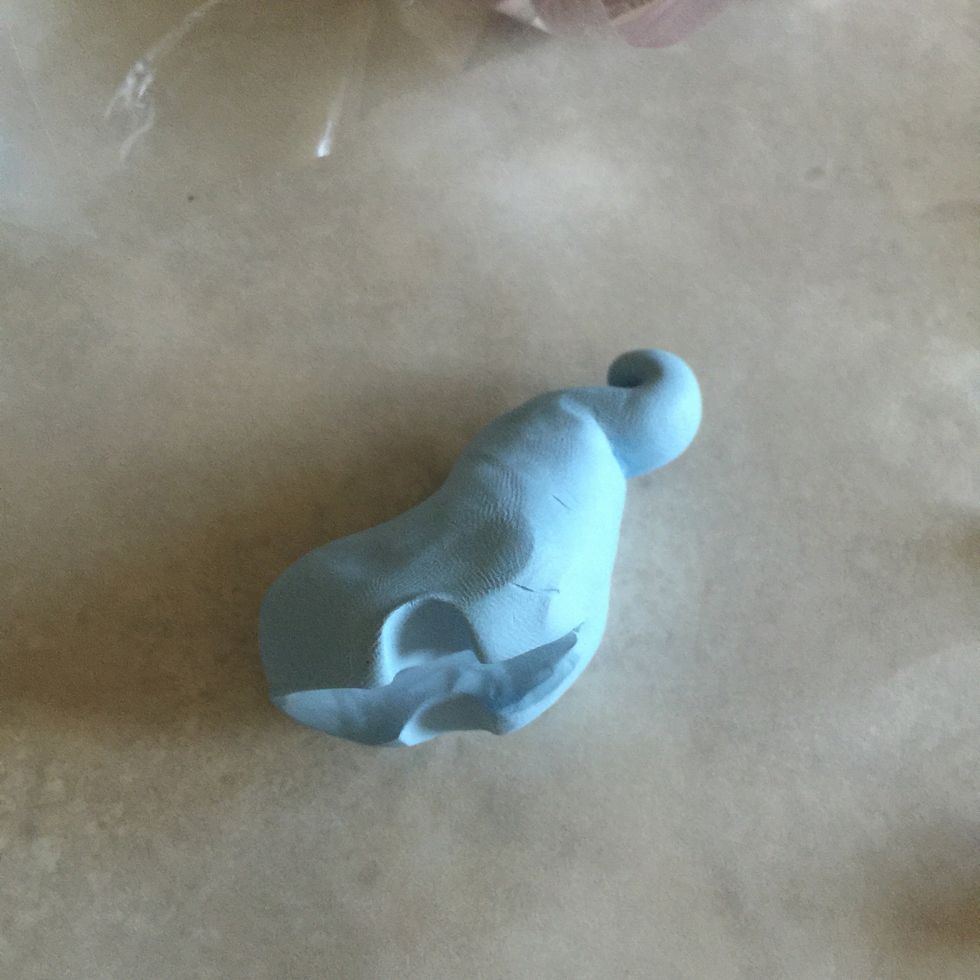 Here, you can see the legs forming. Now start to pull each leg downwards, elongating each one to create a round or square leg (your preference!).