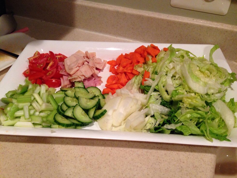 Here you see all veggies I like on my salad. Celery, Cucumber, onions, lettuce, carrots, chicken/ham slices, and tomatoes.