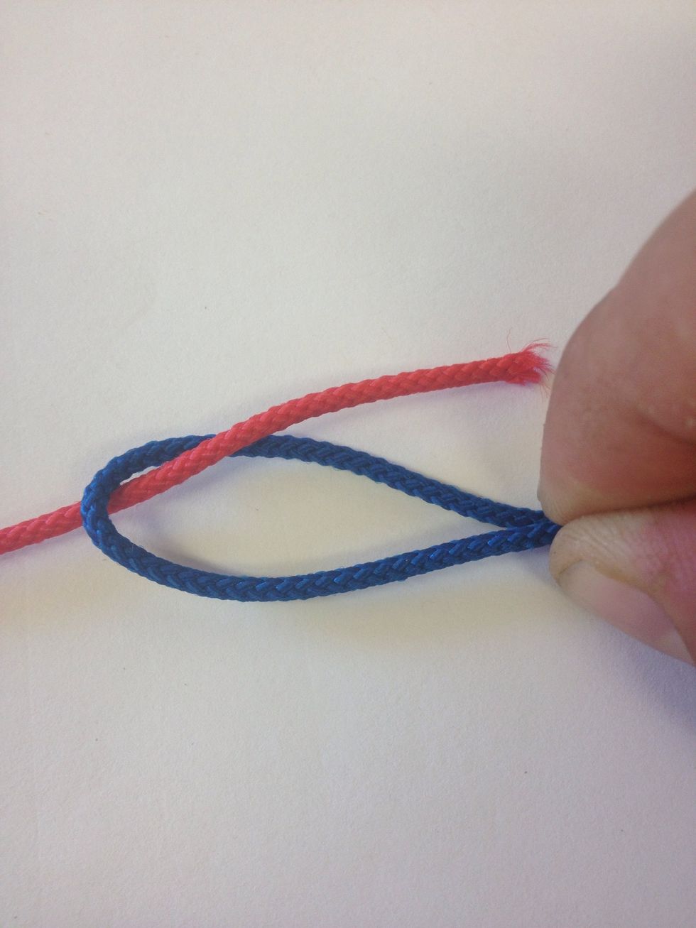 Heres holding the loop. Next run the other line through it.