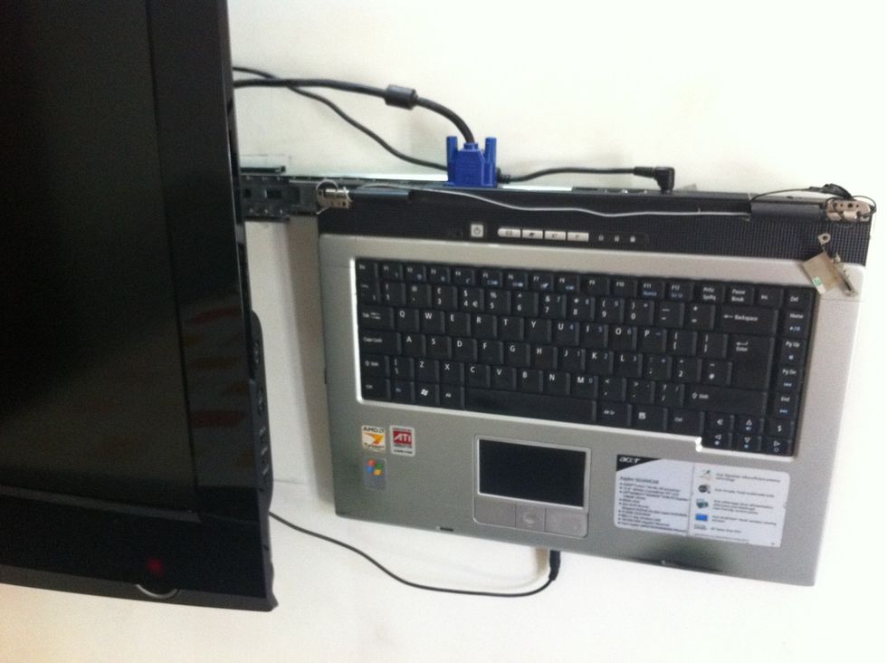 Hide the laptop power adaptor behind the TV and connect the display cable, power cable and headphone cable to the laptop