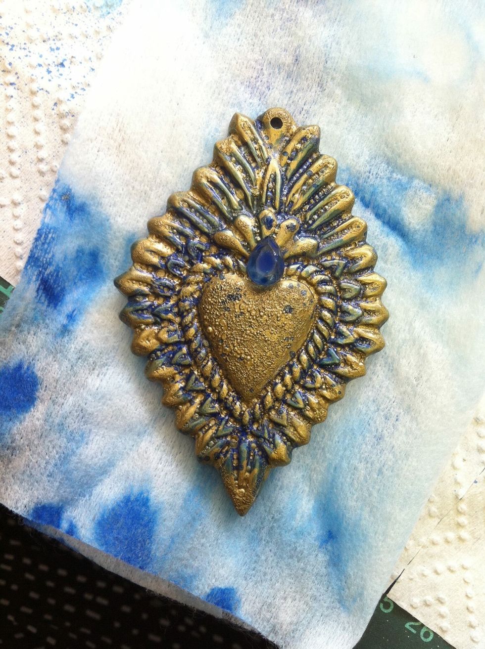 Highlight flames with gold paint and adhere gem!!!