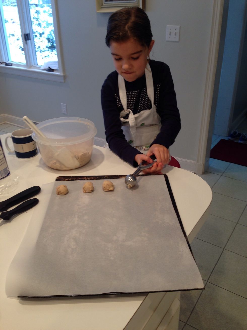 Hildegard is showing you how to space the cookies. They don't spread much. When the sheet is covered, bake them at 325 for 15 minutes, give or take. They should have brown bottoms.