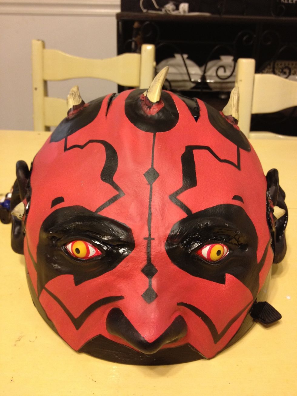 His eyes needed extra glue and paint to fill in and cover the blue of the helmet.