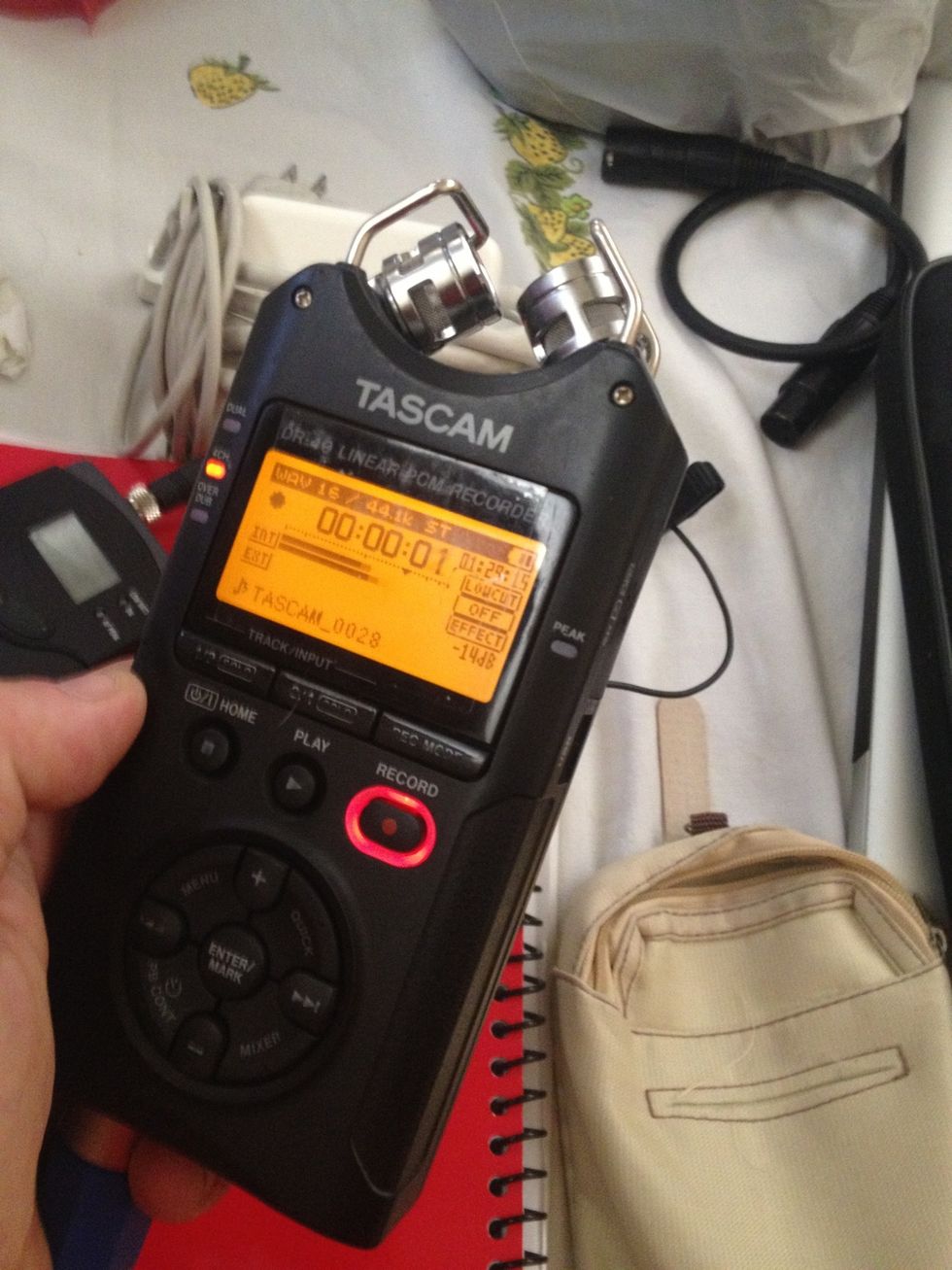 Hit Record once to put it in record-pause. At this point you can hear thru the headphones. Use the up and down buttons on left side to turn mic volume if it is way high or low. Probably just leave it.
