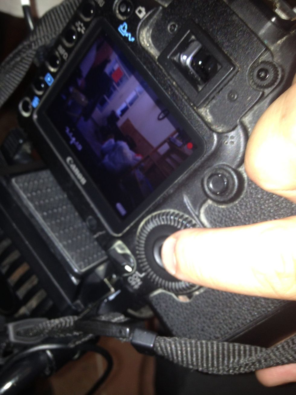 Hit the live view button (above screen to left, just out of this pic) to turn on screen. Hit button in center of dial to record.