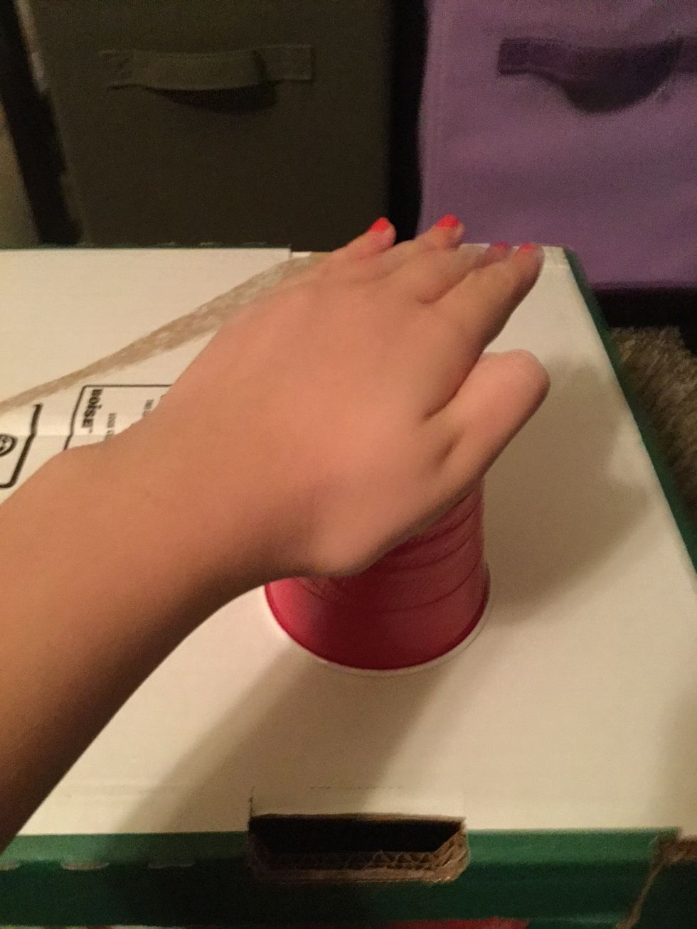 Hit the top of the cup w/ your left hand.