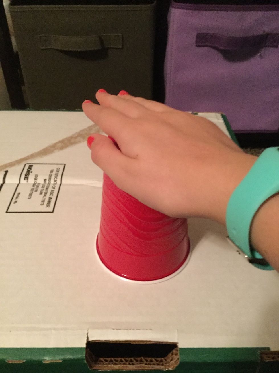 Hit the top of the cup w/ your right hand.