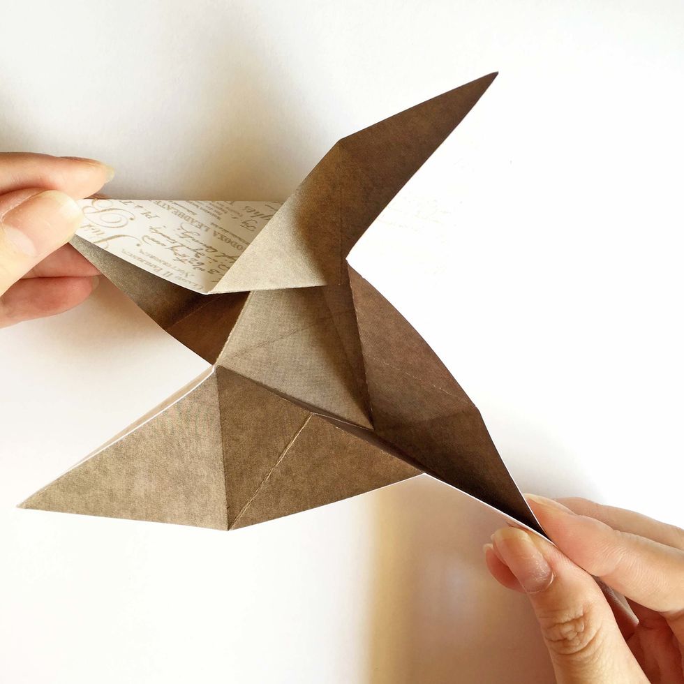 Hold 2 adjacent ends, start to twist the paper...