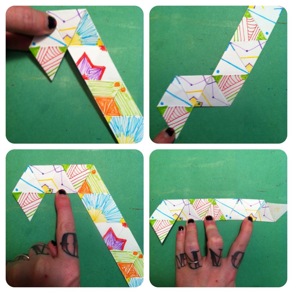 Hold 3 triangles on left & bring strip down. Leave 3 triangles in horizontal line & bring strip back 'n up. Leave 4 triangles in line & bring strip down. Continue wrapping strip around itself.