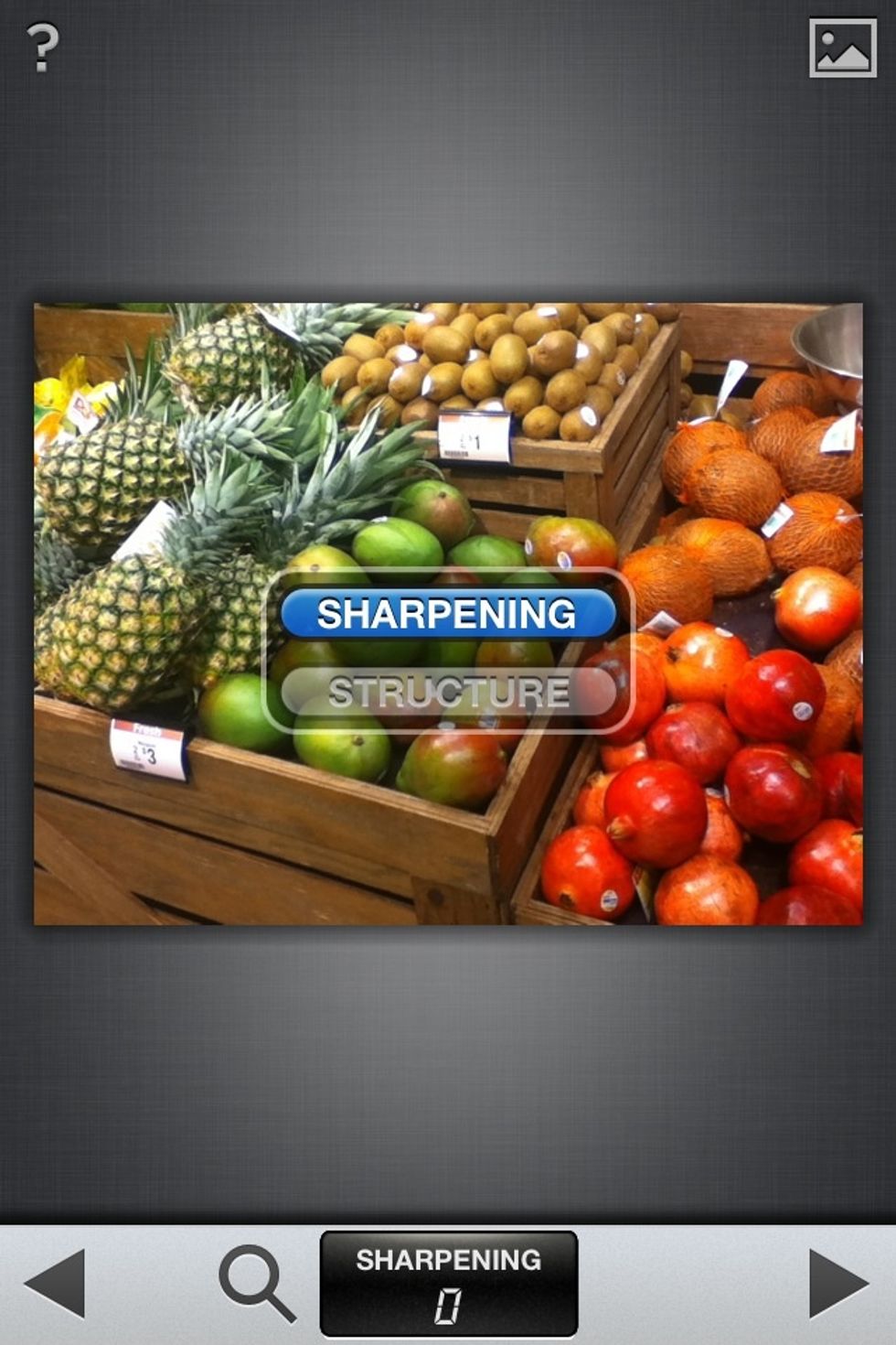 Hold a finger on the photo and move it UP a little. A small menu will be up so long as your finger is down. Moving your finger up and down will allow you to select from the menu. Choose SHARPENING.