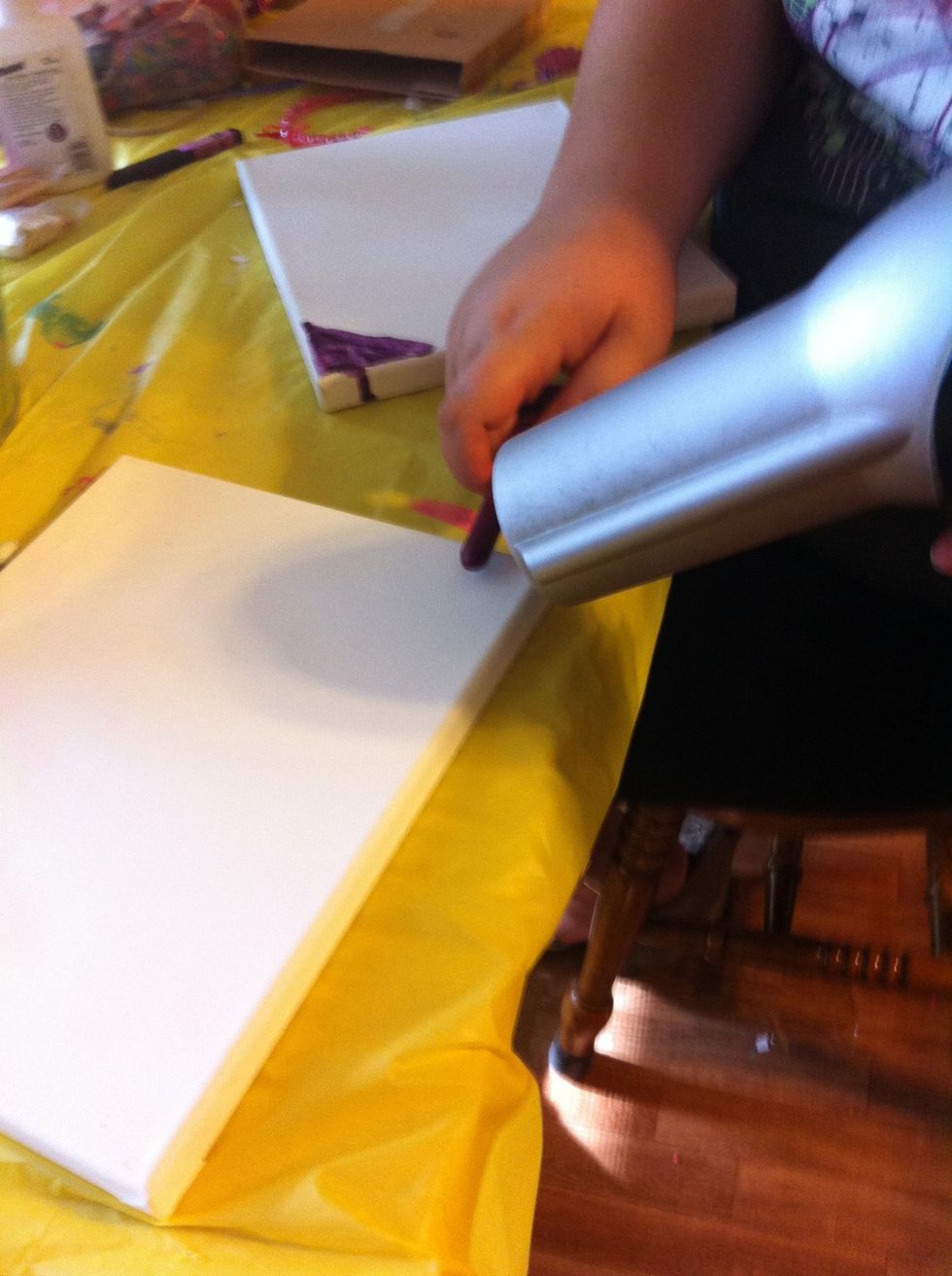 Hold crayon above canvas and blow dry it!