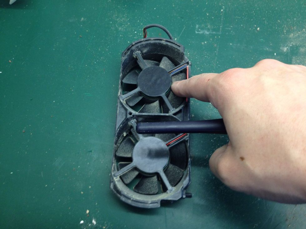 Hold each fan still and brush off the fan blades, flip over and repeat.