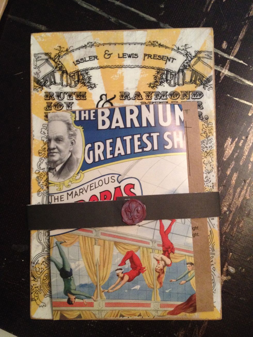 Hold everything together with a slim strip of paper and wax seal.