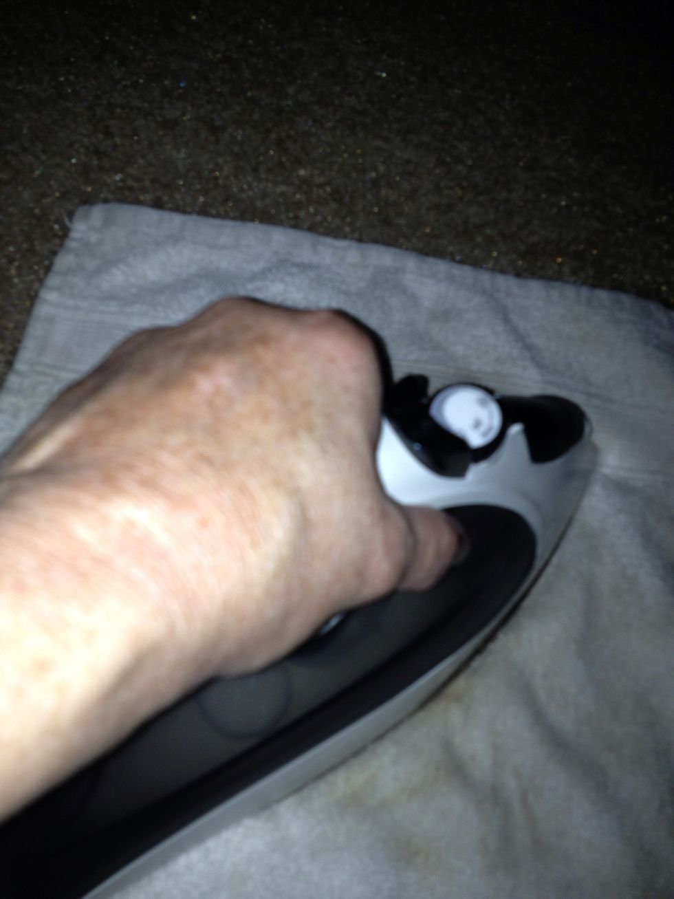 Hold iron on towel for 20 second lift iron and repeat around 6 times then lift towel and check the spot
