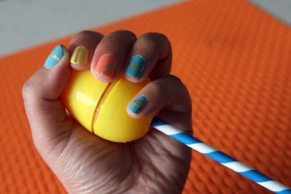 Hold it in your hand for a few seconds to melt it ever so slightly before pulling the top off.