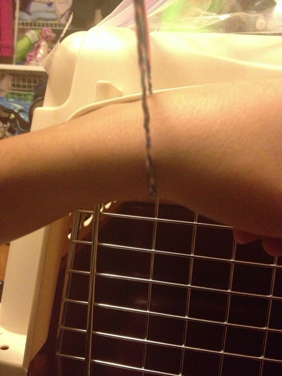 Hold it up again and wrap it around your wrist when it's as long as you want it for you wrist keep going longer cause you will push it up and it will get smaller