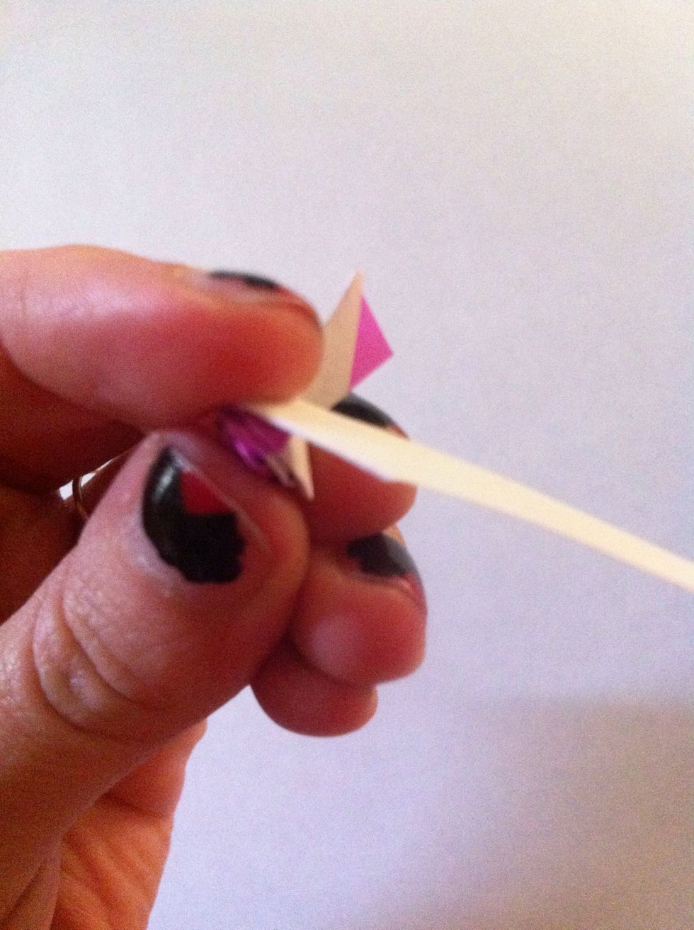 Hold it upside down w/ your thumb on the top part of the rose & your index finger holding the bottom. This will keep your rose from getting all wonky as you fold back & roll.