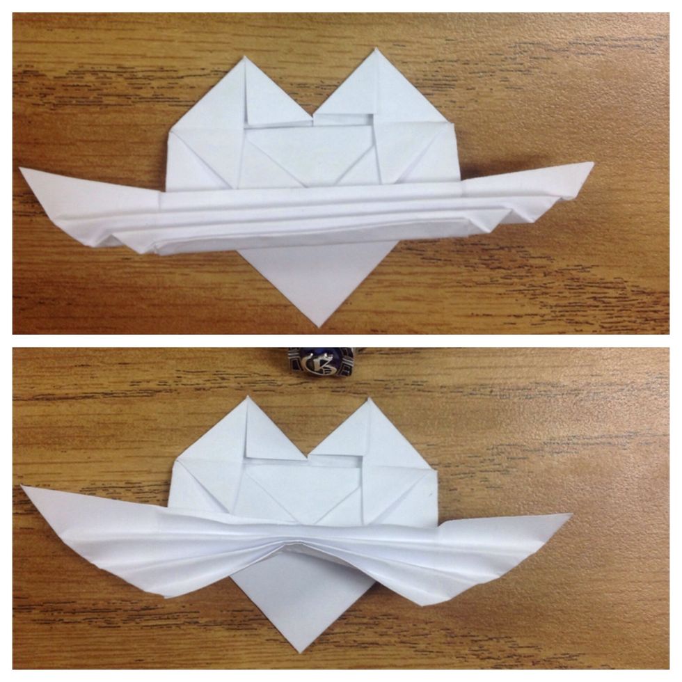 Hold on the center of the pleats while gently pulling down both sides to form and inverted "V".