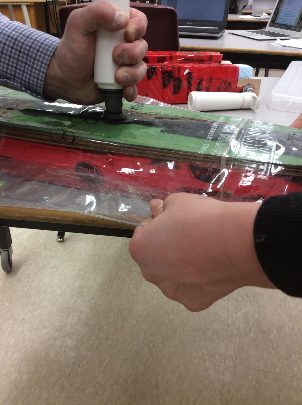 Hold sides of vacuum bag away from veneers as the air is evacuated.