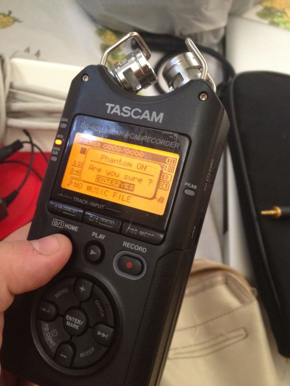 Hold Stop button to power on recorder and hit Enter (yes) to phantom power. That powers the shotgun mic, which should be plugged in on bottom also (left or right).