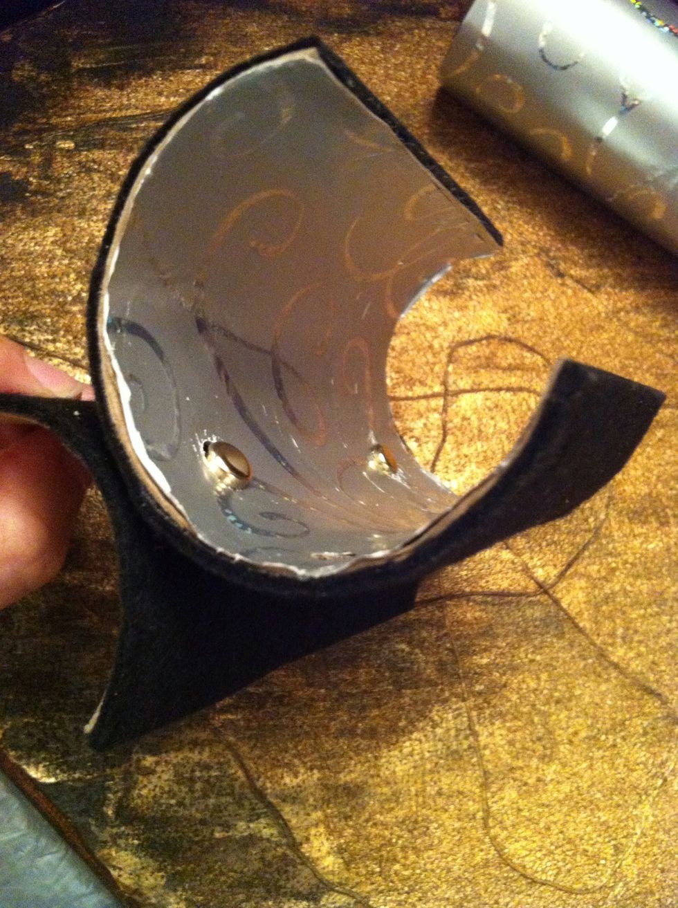 Hold the base and holder together, aligning the holes. Push the fastener through the napkin holder's inside...